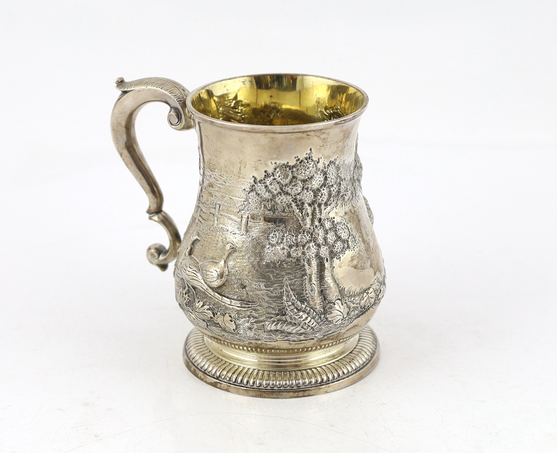 A George II silver baluster mug, by David Willaume II, later decorated with continuous countryside scene with hares and game birds